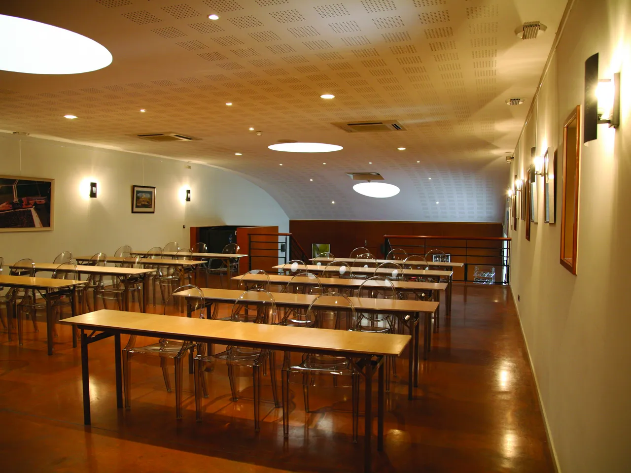 Modern conference room with wooden tables, transparent chairs, and ambient lighting in Bordeaux