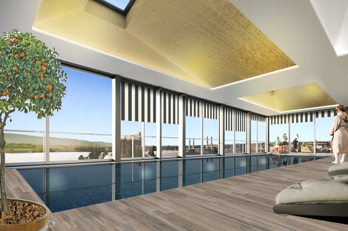 Modern luxury indoor swimming pool with floor-to-ceiling windows overlooking a panoramic view of Bordeaux's landscape, featuring vertical black louvered screens, wooden deck, and contemporary ceiling design with ambient lighting.