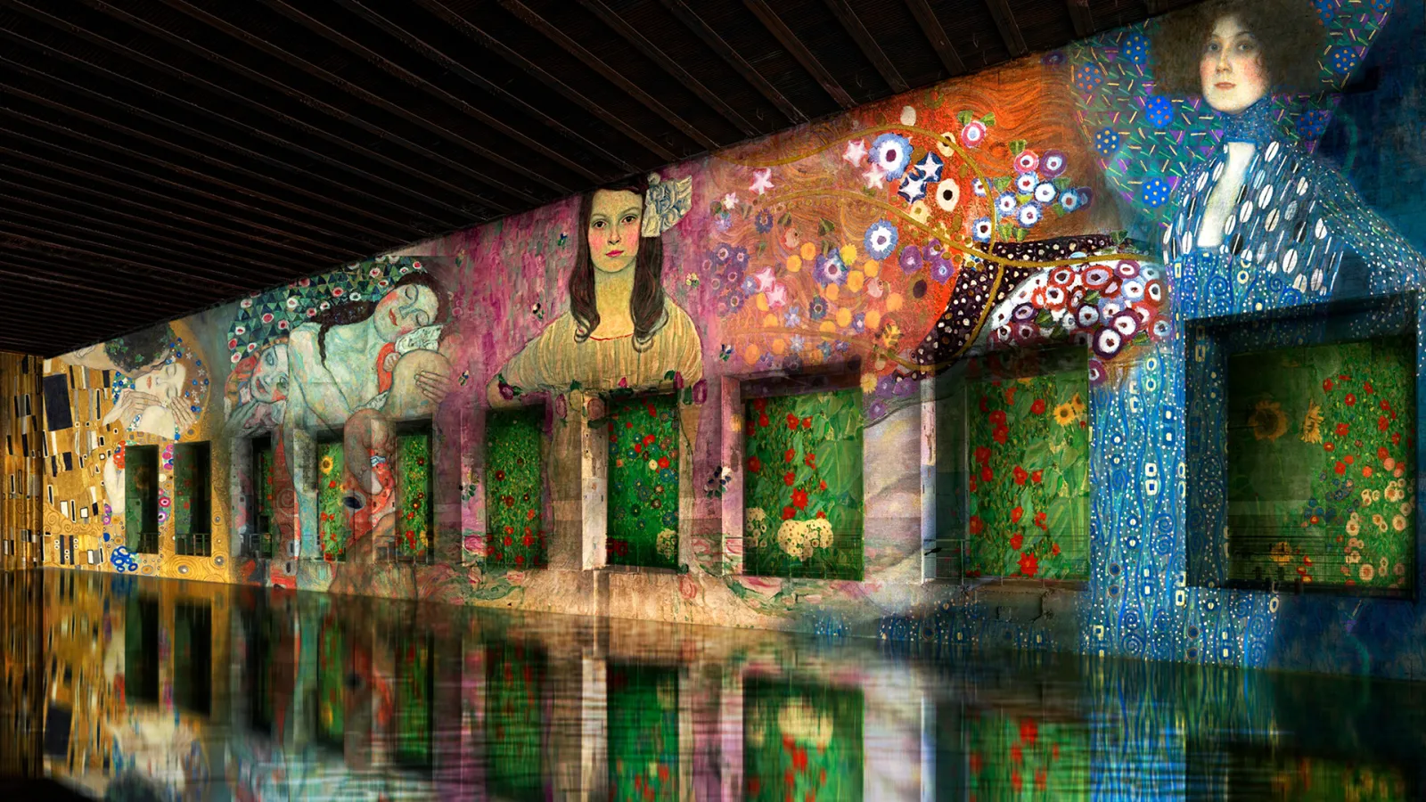 Immersive digital projection at Bassins des Lumières in Bordeaux featuring colorful artistic murals with figures, floral patterns, and decorative elements reflected in water below