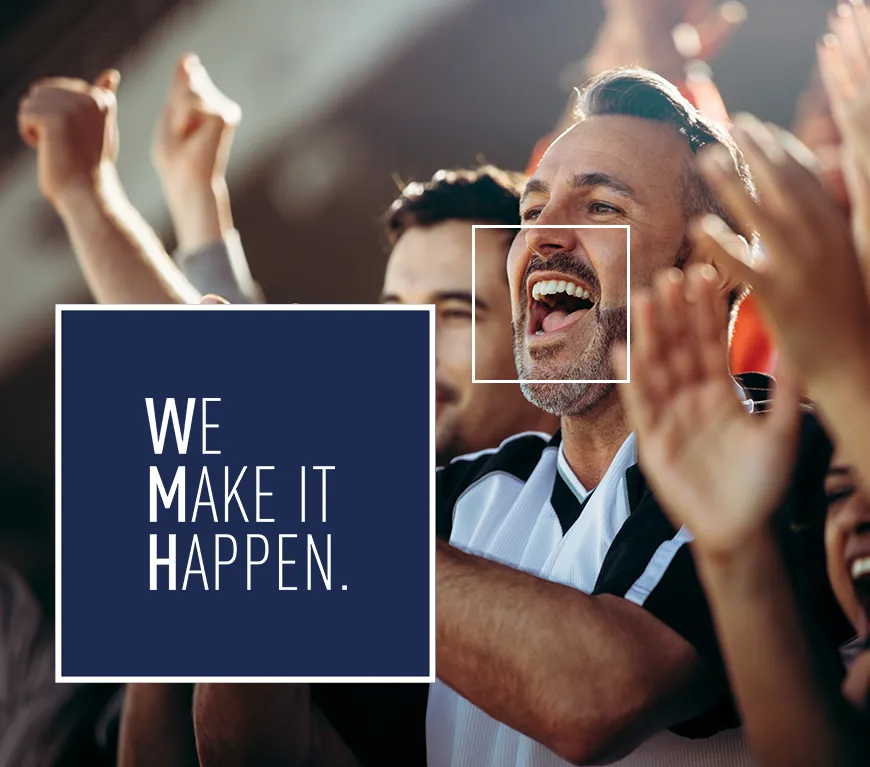 A man in business attire smiling and celebrating with a crowd of people with raised hands, with the text 'WE MAKE IT HAPPEN' displayed on a dark blue overlay