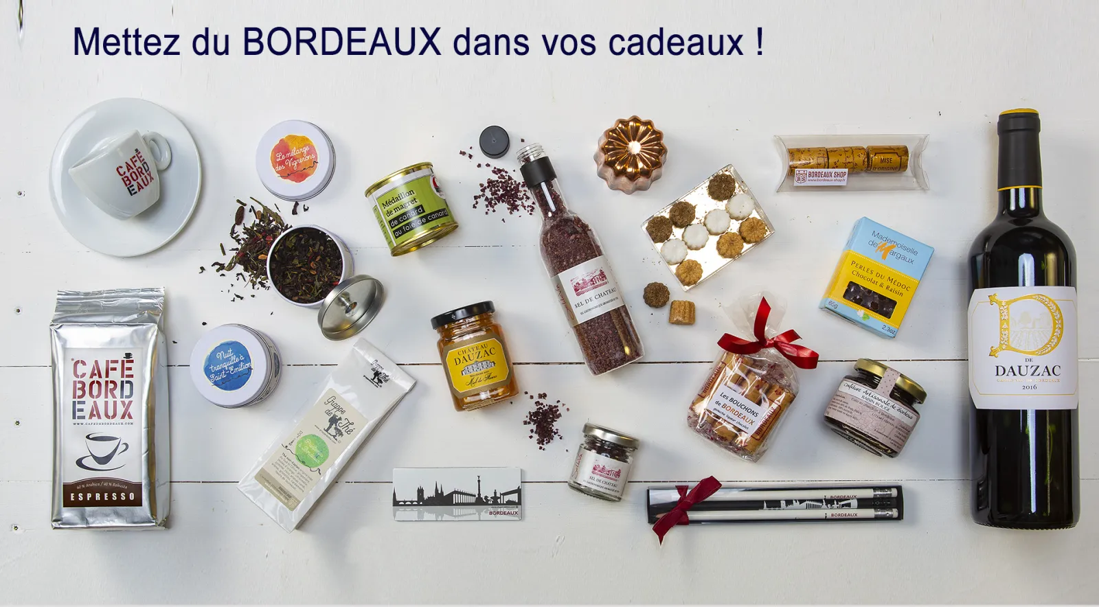 Bordeaux gift collection featuring coffee, wine, tea, chocolates, pastries, and local specialty products arranged on a white surface with the text 'Put Bordeaux in your gifts'