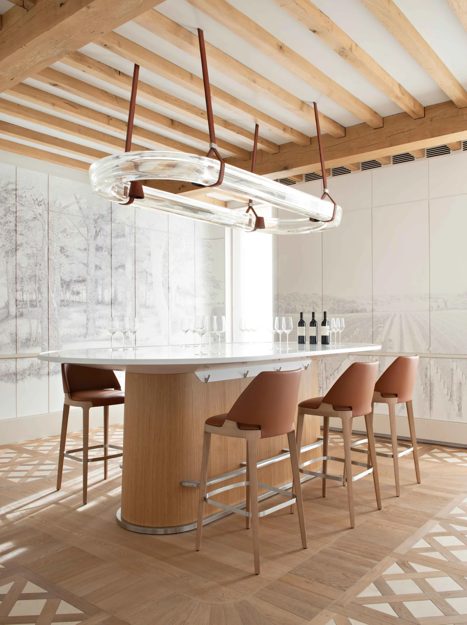 Modern kitchen with curved island bar, cognac-colored leather bar stools, wooden ceiling beams, contemporary pendant lighting, and floor-to-ceiling windows overlooking a landscape