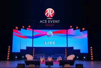 ACE EVENT GROUP stage setup for Forum Franchise Live event in Bordeaux, featuring a modern blue and pink digital display with basketball logo, professional seating area, and ambient lighting