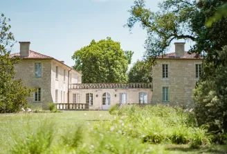 Château de Ferrand near Bordeaux, a stone manor house with two towers connected by a central wing, featuring classical balustrades and surrounded by manicured lawns and mature trees
